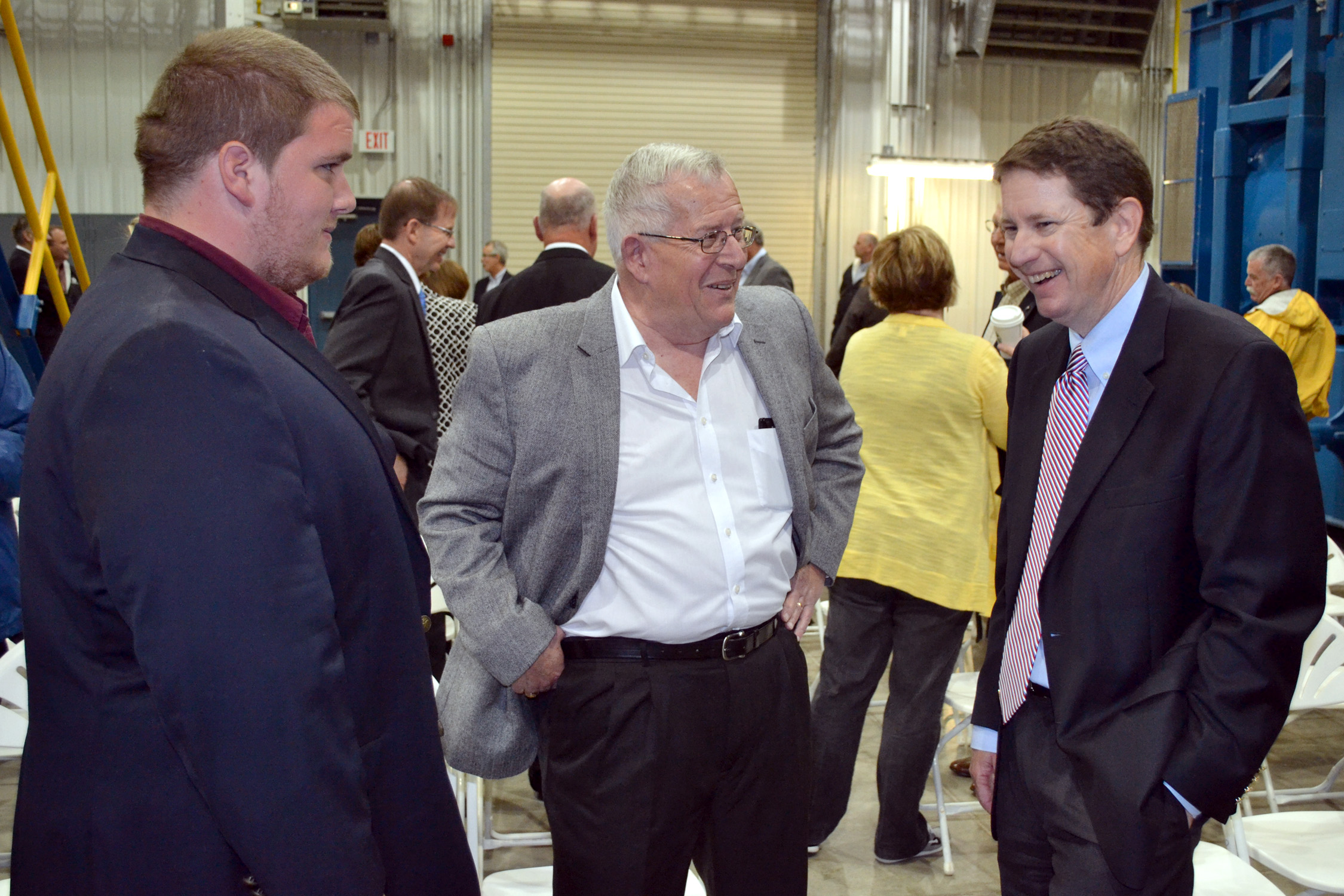 (L to R) Daniel Goodman, grandson of the late Jack Goodman, and his father Marc Goodman, share a laugh with Stuart Lowry, CEO of Sunflower Electric, at the Goodman Energy Center dedication.