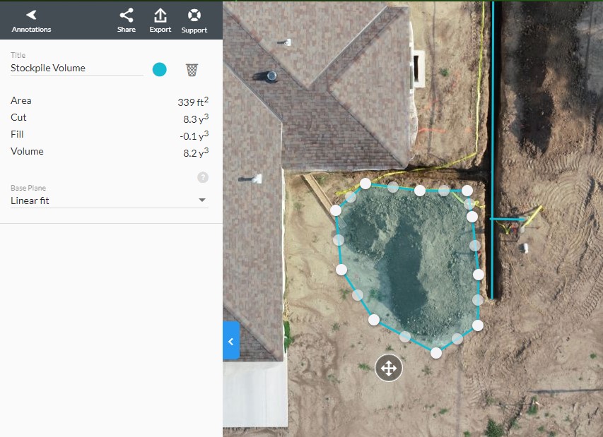 An aerial image, taken by drone, of a newly constructed home; behind the home is a trench for a new gas line, and the drone has calculated the volume of dirt removed from the trench.