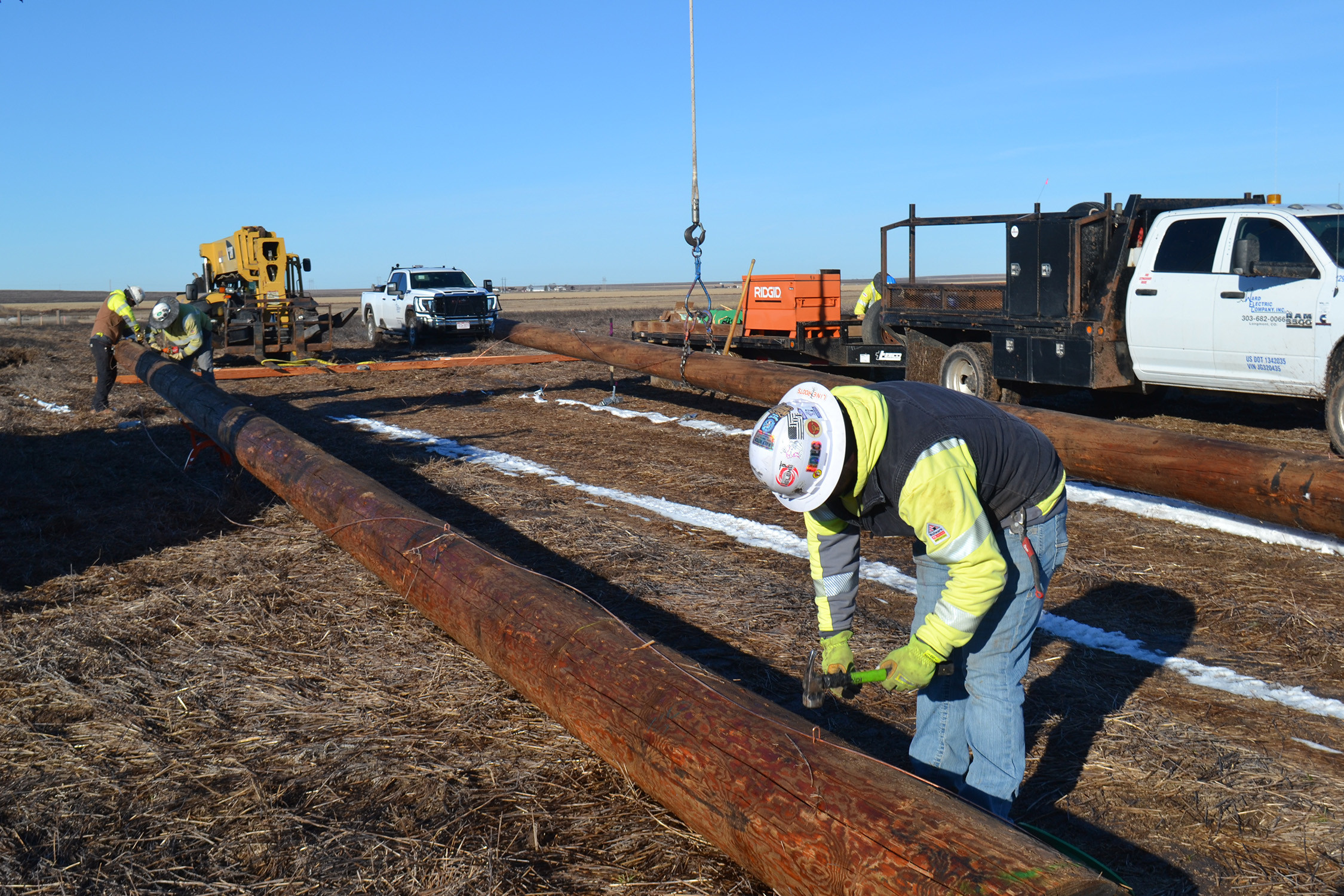 A Ward Electric crew frames up one of 247 new H-frame structures along a 25-mile stretch of transmission line between Nekoma and Ness City.