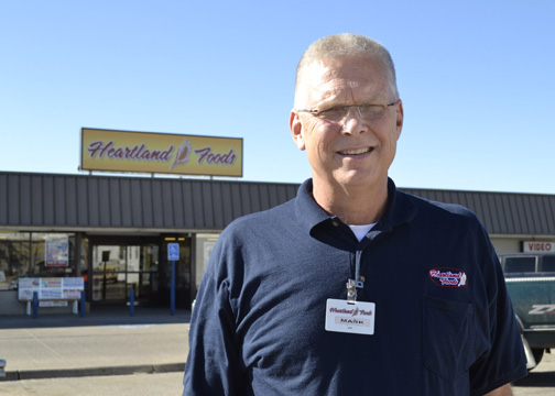 Mark Watkins, owner of Heartland Foods in Oakley, calls Midwest Energy