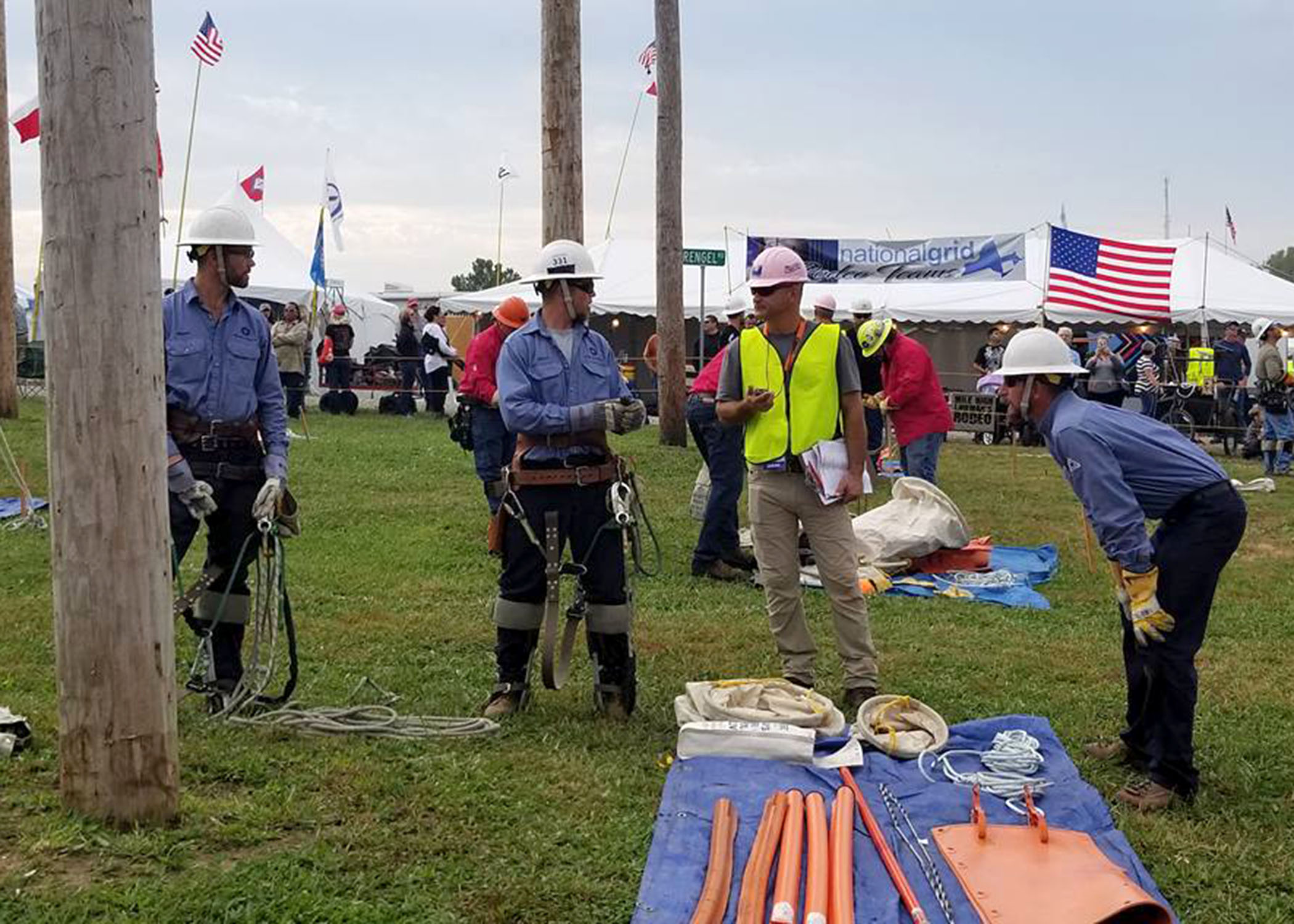 A photo of Midwest Energy’s Hays Journeyman team, of Shawn Slaubaugh, Butch Hamel and Brian Legleiter, discusses an upcoming event with a judge at the International Lineman’s Rodeo in Bonner Springs, Oct. 14.