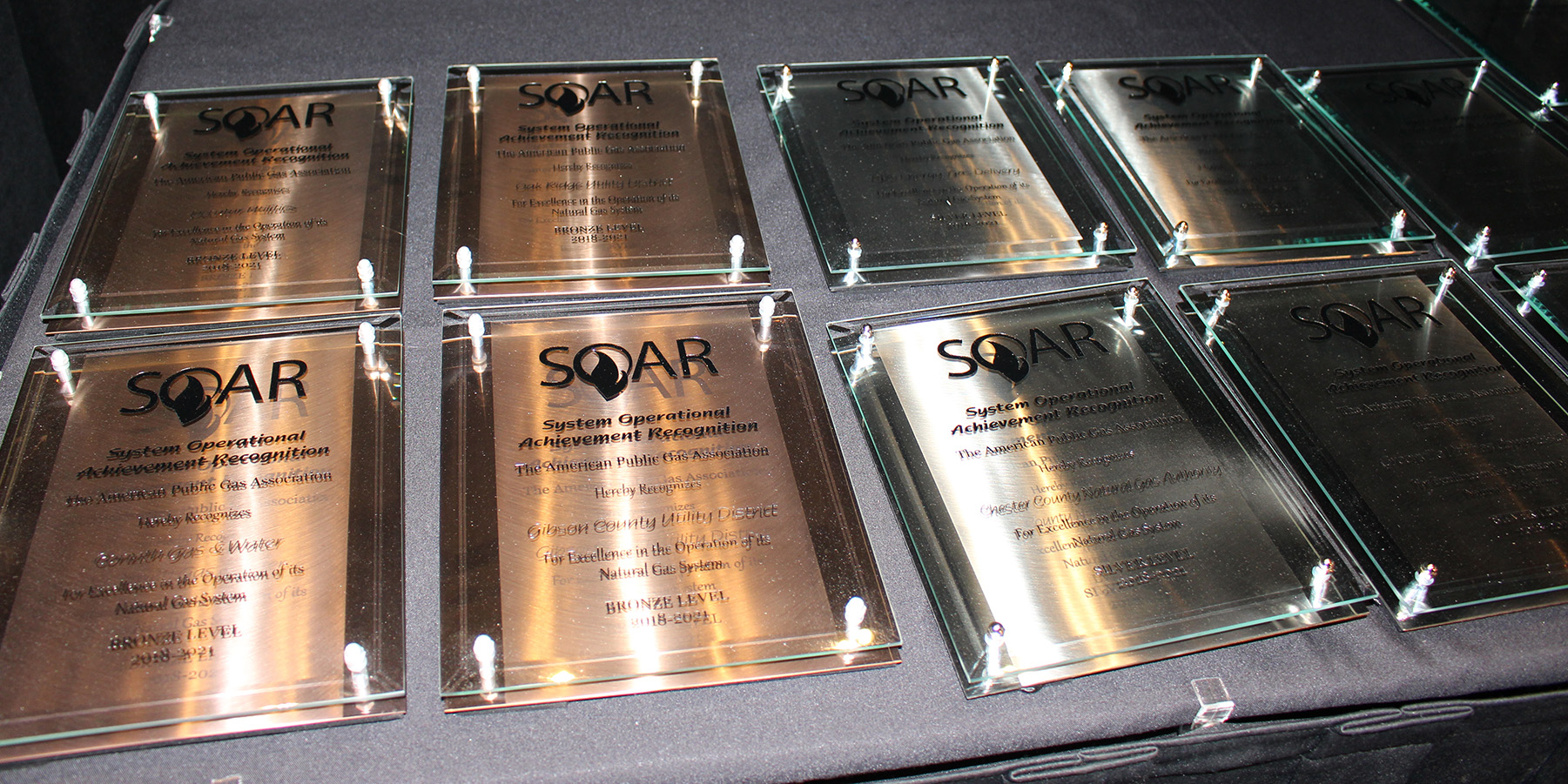 A photo of several award plaques laid on a table; Midwest Energy was one of just 18 natural gas utilities nationwide to receive the APGA's prestigious SOAR award for 2018.