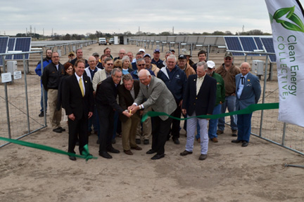 Watching the ribbon cutting is Rep. Billinger (yellow tie); cutting are Clean Energy Collective VP for Development Jim Hartman; MWE General Manager Earnie Lehman, and Sen. Ostmeyer; right of him is Rep. Hineman.