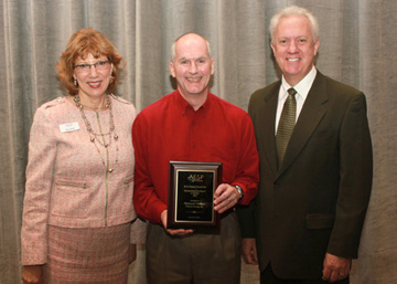 Meg Matt, President and CEO of AESP and John Hargrove, AESP chair, present Midwest Energy's Michael Volker (center) with AESP's B.H. Prasad Award on Feb. 1 in Orlando, Fla.