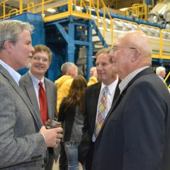 (L to R foreground) Gary Moss, member of Midwest Energy's Board of Directors, talks with Senator Ralph Ostmeyer (R-Grinnell) at the Goodman Energy Center dedication, while Bill Dowling, Midwest Energy's VP for Engineering and Energy Supply, and Rep. Rick Billinger (R-Goodland) listen.  