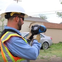 A Midwest Energy using a laser leak detection device.