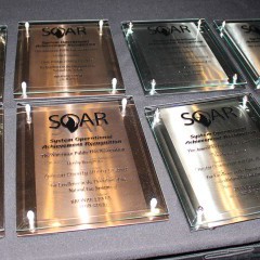 A photo of several award plaques laid on a table; Midwest Energy was one of just 18 natural gas utilities nationwide to receive the APGA's prestigious SOAR award for 2018. 