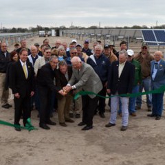 Watching the ribbon cutting is Rep. Billinger (yellow tie); cutting are Clean Energy Collective VP for Development Jim Hartman; MWE General Manager Earnie Lehman, and Sen. Ostmeyer; right of him is Rep. Hineman.