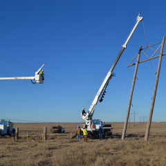 An electric crew works to remove an H-frame transmission structure