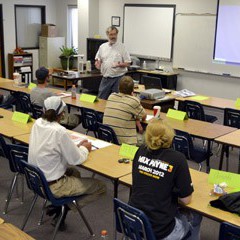 Steve Swartz, Business and Manufacturing Technology instructor from Hutchinson Community College, goes over testing procedures with students enrolled in the Workforce AID program at NCK Tech in Hays.