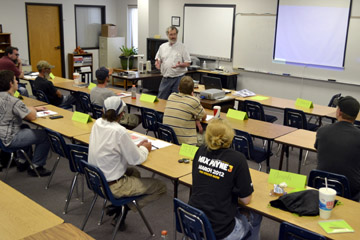 Steve Swartz, Business and Manufacturing Technology instructor from Hutchinson Community College, goes over testing procedures with students enrolled in the Workforce AID program at NCK Tech in Hays.